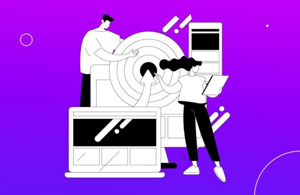 An illustrated scene of a web designer working at a desk with computers and design elements on a bright magenta background.